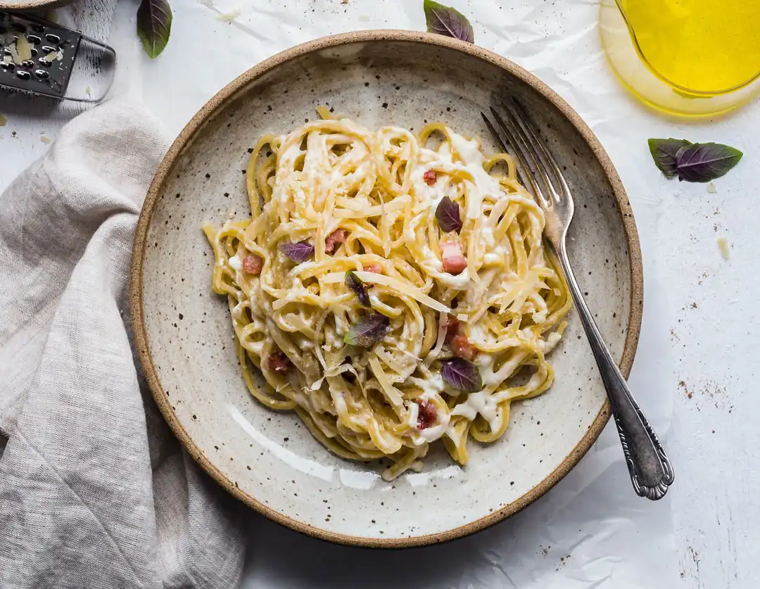 Pasta carbonara photographed from above on a rustic plate